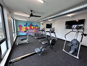 Des Moines apartment for rent - Modern gym with rows of cardio equipment.